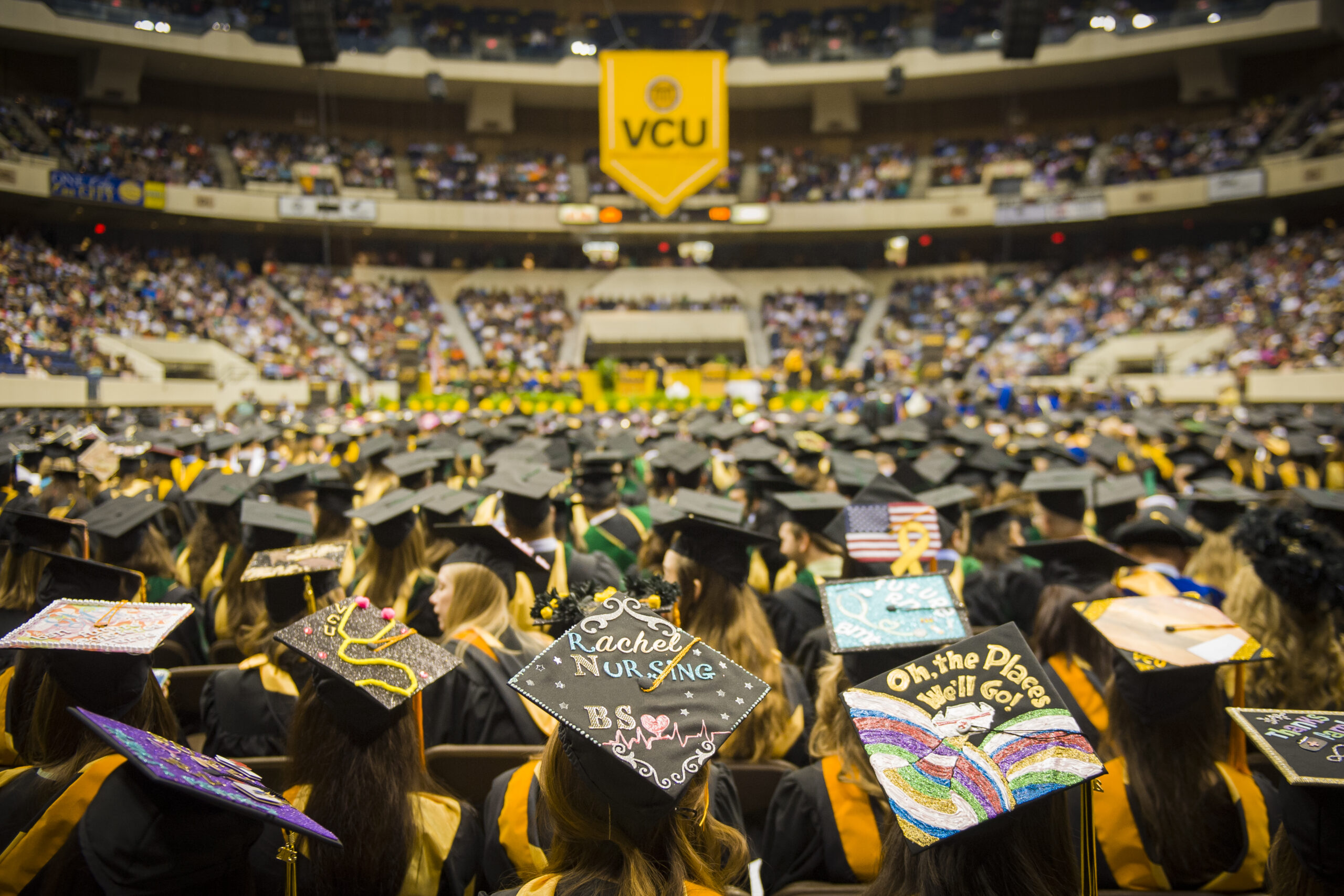 Graduating students sitting in a stadium at Virginia Commonwealth University