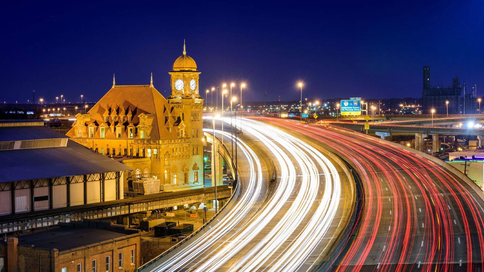 I-95 looping past cargo and passenger rail at Main Street Station