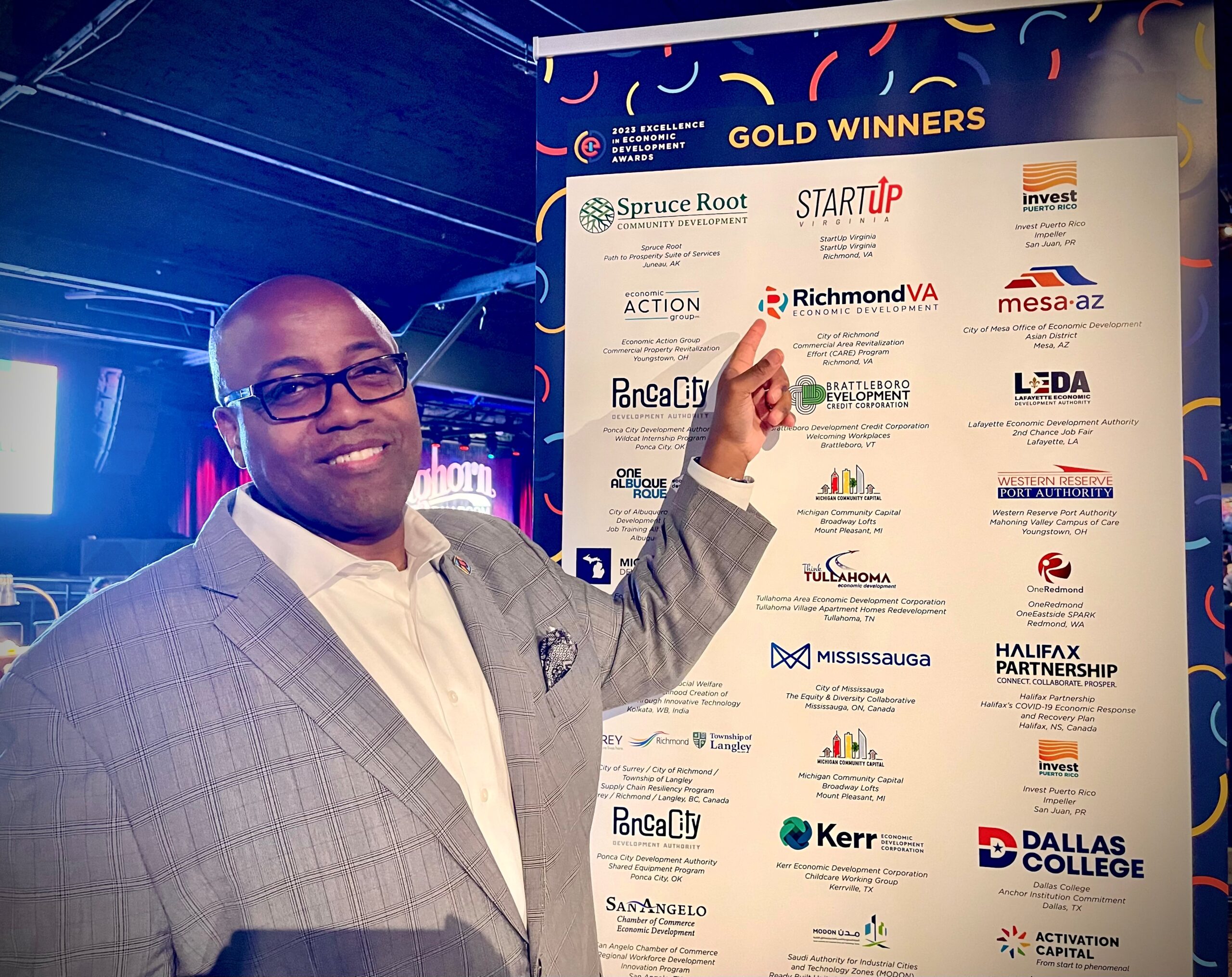 Leonard Sledge at IEDC man shown pointing at banner